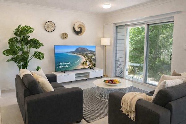 Bright living area with air conditioning and comfortable seating