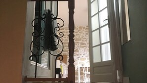 A staircase with a wooden handrail and a metal balustrade. - Very charming 1 bed room in heart of paris with balcony (Paris)