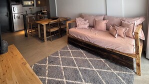 Una cocina moderna con horno empotrado y comedor con mesa y sillas de madera.