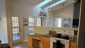 A kitchen with a stove, oven, and granite countertop. - Peaceful Two Bedroom Apartment in Charming Weaverville. (Weaverville)