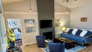 A modern living room with a sofa, chairs, a coffee table, and a TV. - Peaceful Two Bedroom Apartment in Charming Weaverville. (Weaverville)