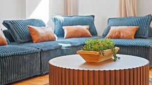 A modern living room with a sofa set, a round wooden coffee table, and a potted plant. - Summit Stay Near Kalahari & Raceway (Pocono Summit)