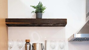 A kitchen with wooden shelves, a coffee maker, jars, and a plant. - Summit Stay Near Kalahari & Raceway (Pocono Summit)