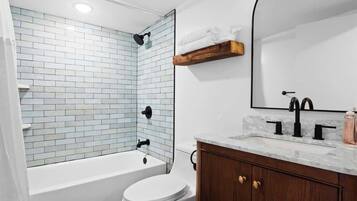 Shower, hair dryer, towels, shampoo
