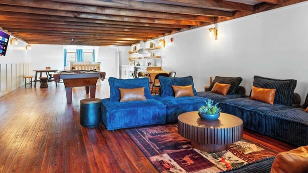 A spacious living area with a pool table, blue sofas, and a round coffee table. - Lakeside Serenity Retreat Near Kalahari Resort (Pocono Summit)