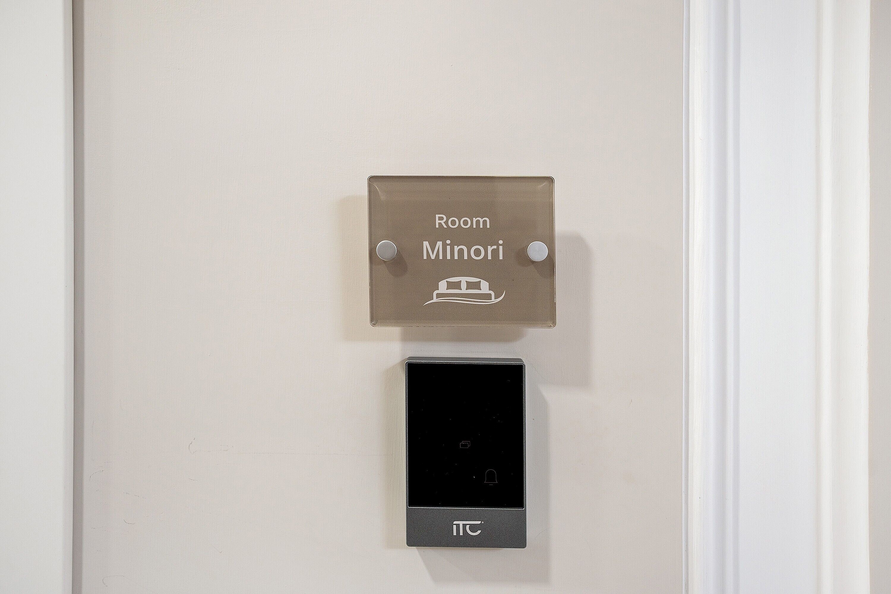 A door with a sign indicating 'Room Minori' and a digital lock below it.