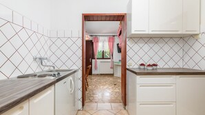 A kitchen with white cabinets, a wooden countertop, and a tiled backsplash. - Apartman Seaside 064 by Villas Guide (Pula)