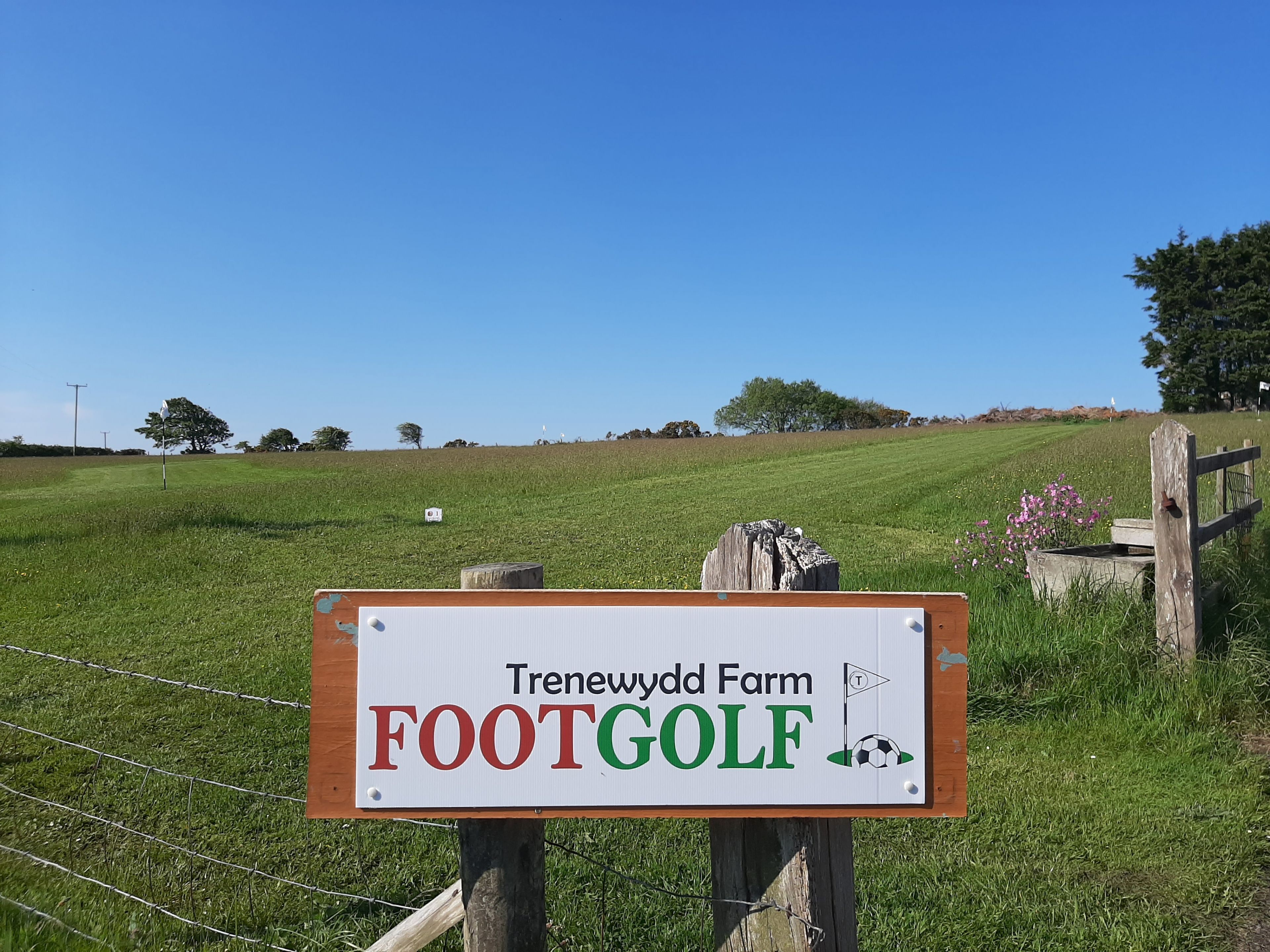 A sign for Trenewyddd Farm FootGolf with a soccer ball icon.