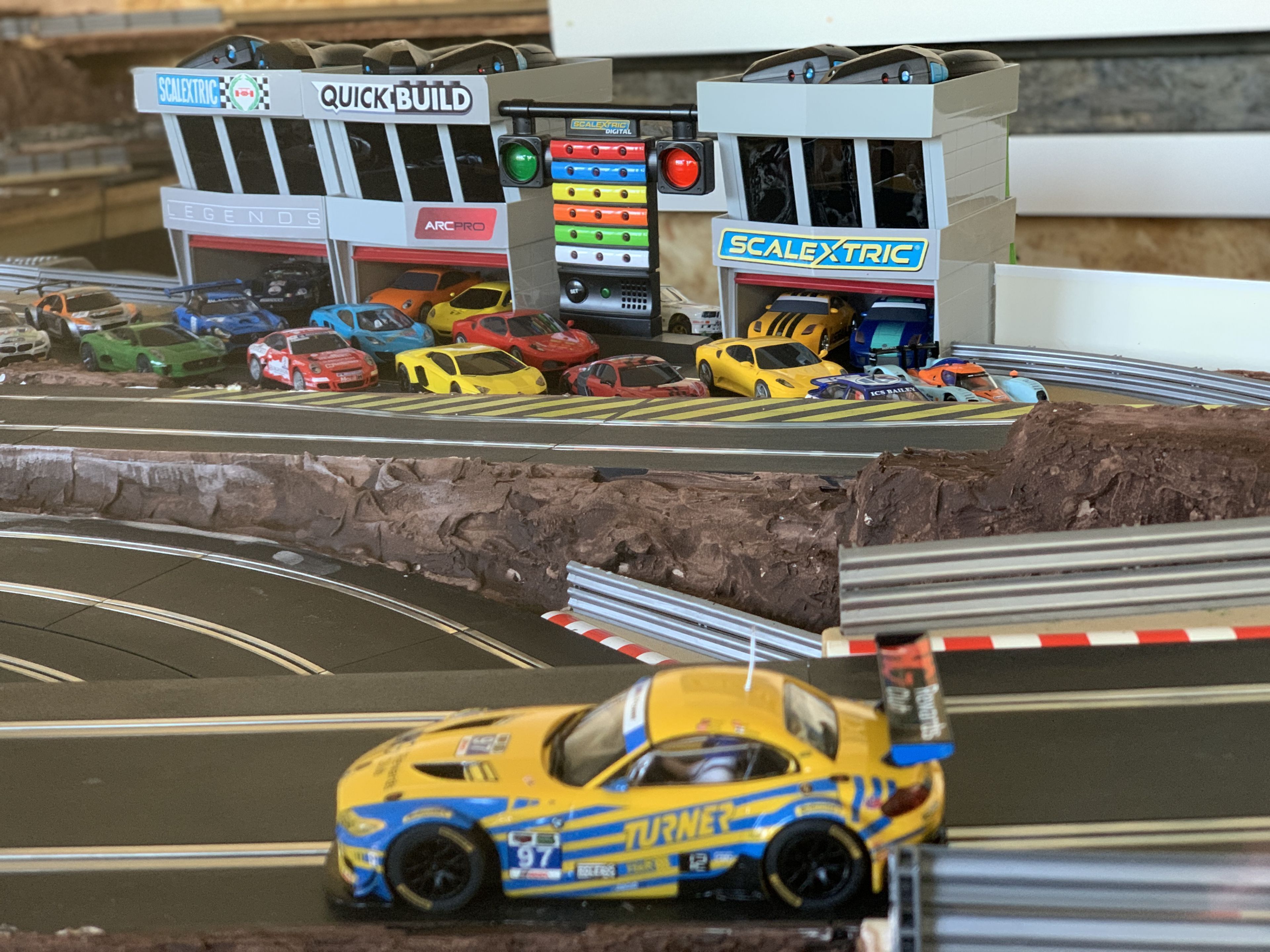 A model car track with multiple lanes and a variety of cars.