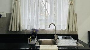 A kitchen with a sink, a dish rack, and a bottle of hand soap. - Farmhouse Retreat on 85-acre tea Estate - 2331 (Limuru)