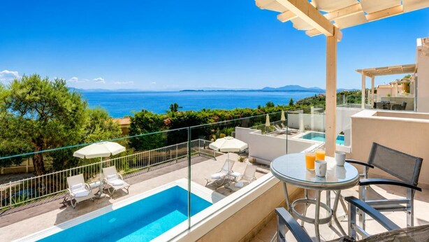 A balcony with a pool, lounge chairs, and a table with drinks. - Villa Stavroula - Two Bedroom Villa, Sleeps 4 (Mparmpati)