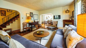 A living room with a sofa, coffee table, and a staircase. - DV-627 Walk to Breweries! Pets OK! (Davis)