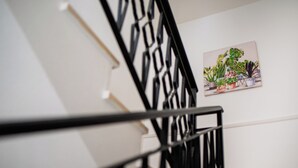 A staircase with a black railing and a wall-mounted plant arrangement. - VILLA HEMINGWAY - ALESSIA'S HOUSE BREATHTAKING SEA VIEW (Ficarazzi)