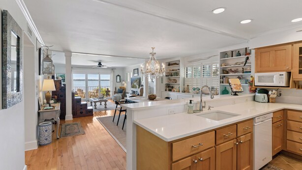 A modern kitchen with a large island, wooden cabinets, and a built-in microwave. - Ocean Front Escape sleeps 4 (St Simons Island)