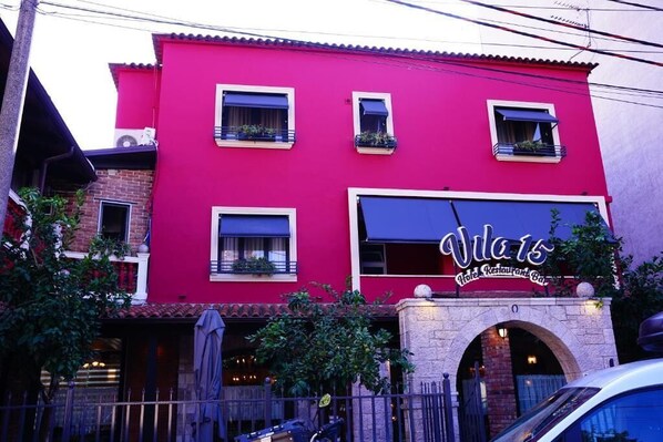 A red building with a sign reading "Vila 15 Hotel Restaurant Bar". - Vila 15 by Nam Nam (Tirana)