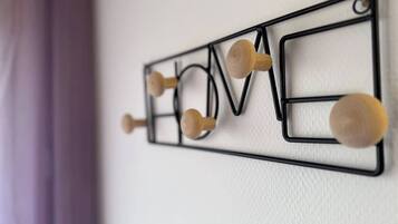 A wall-mounted decoration with the word "LOVE" spelled out in letters, each letter having a wooden knob.