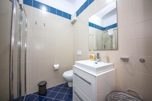 Family Apartment, Balcony, City View | Bathroom | Shower, hair dryer, slippers, towels
