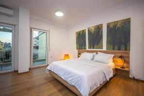 Family Apartment, Balcony, City View | Desk, blackout drapes, soundproofing, iron/ironing board