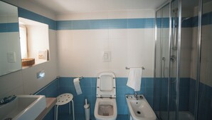 A bathroom with a bathtub, two toilets, a bidet, a shower, and a mirror. - Home Salvator Rosa 78  (Naples)