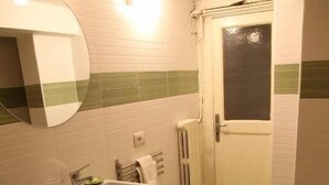A bathroom with a sink, mirror, towel rack, and toilet. - Home Salvator Rosa 78  (Naples)