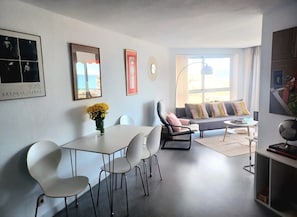 A modern living room with a dining area, a sofa, and a coffee table. - Apartment 'Sea View' with Ocean Views, Wi-Fi, and Air Conditioning (Torremolinos)
