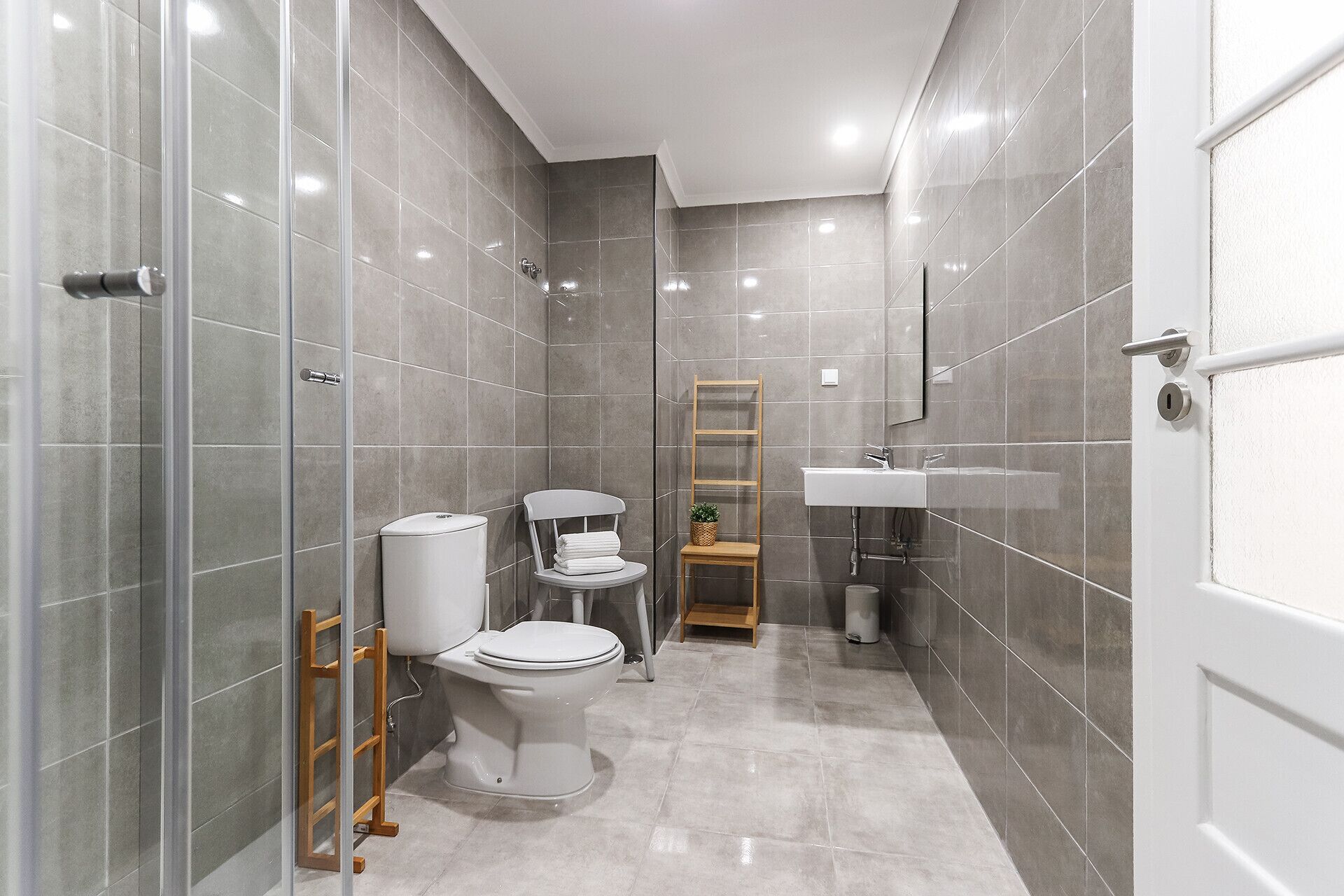 A modern bathroom with a toilet, bidet, and a sink.