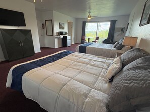A hotel room with two beds, a desk, a chair, a TV, and a ceiling fan. - Schooner #242 @ Bel Arco on Bull Shoals Lake (Bull Shoals)