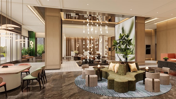 A modern lobby with a central seating area, a large plant, and a reception desk. - Hilton Garden Inn Chengdu Wuhou Jinli (Chengdu)