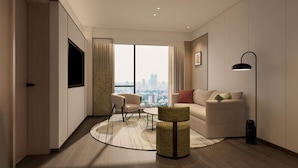 A modern living room with a large window, a sofa, a chair, and a floor lamp. - Hilton Garden Inn Chengdu Wuhou Jinli (Chengdu)