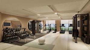 A modern gym with various exercise equipment, a large mirror, and a view of the outdoors. - Hilton Garden Inn Chengdu Wuhou Jinli (Chengdu)