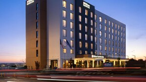 A multi-story hotel with a modern design, featuring a prominent sign for the Hilton Garden Inn. - Hilton Garden Inn Brasov (Brasov)