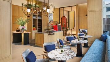 A modern interior with seating areas, a bar, and decorative plants.