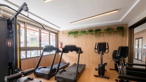 A gym with treadmills, a stationary bike, and a rowing machine. - Fully Equipped Accommodations in a Building With a Pool, 270m From Barra Beach - Caoa (Salvador)