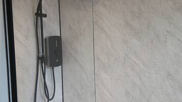 Combined shower/bathtub, deep-soaking bathtub, hair dryer, towels