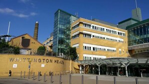 A building with a sign reading 'WHITTINGTON HEALTH' and a modern glass structure.