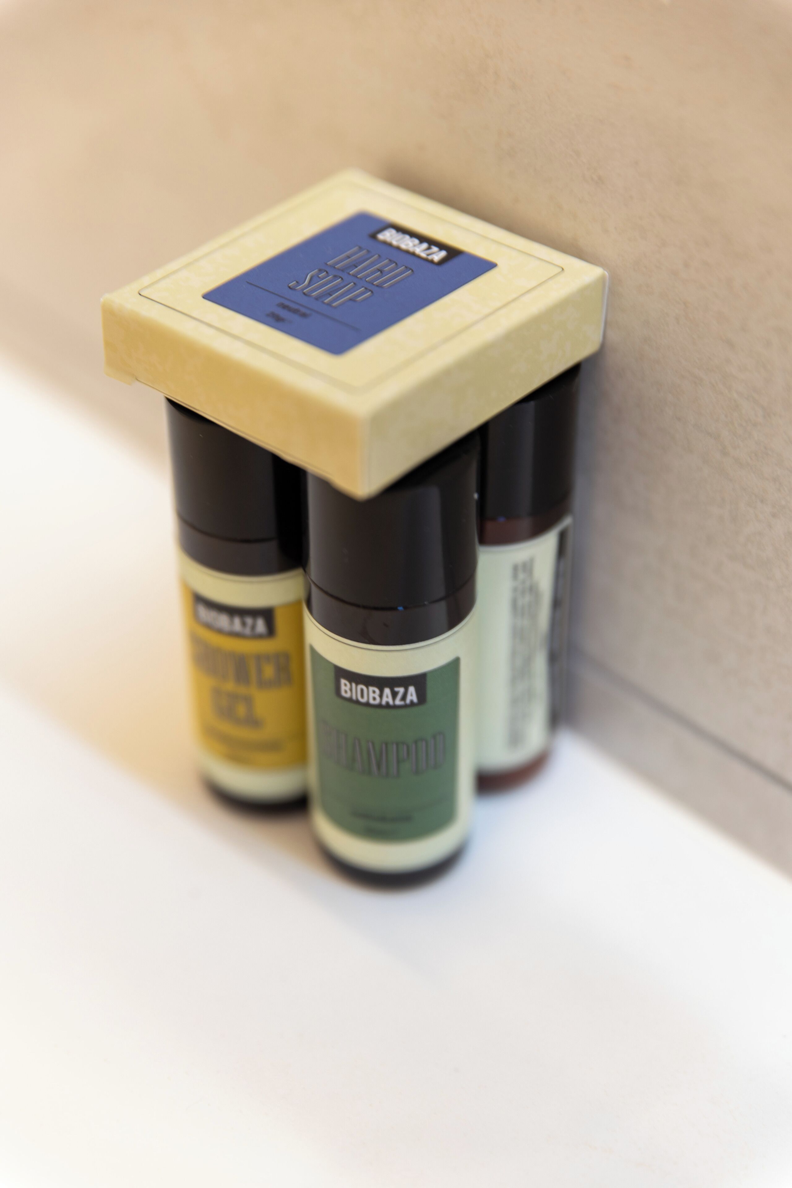 Three Biobaza shampoo bottles on a white surface.