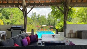 An outdoor patio with a pool, a barbecue grill, and a seating area with cushions. - Roc de Lapalue - Three Bedroom Villa, Sleeps 6 (Montcuq)