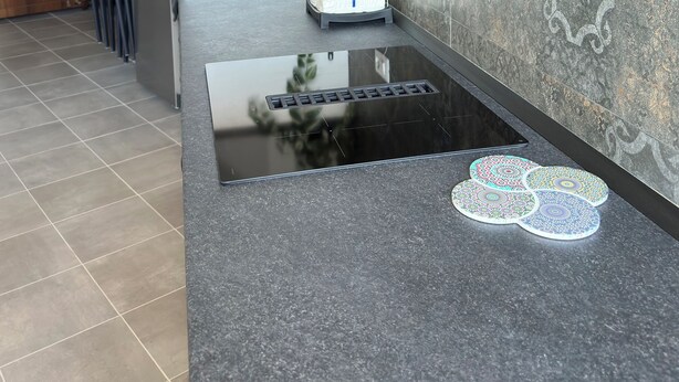 A modern kitchen with a black countertop, stainless steel appliances, and a decorative plant. - C Room with shared bathroom; Sweet Home Fleming (Roma)