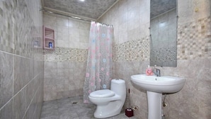 A bathroom with a toilet, sink, and shower curtain. - 21 Apartment in yerevan 02 (Yerevan)