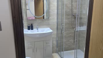 Shower, hair dryer, towels, toilet paper