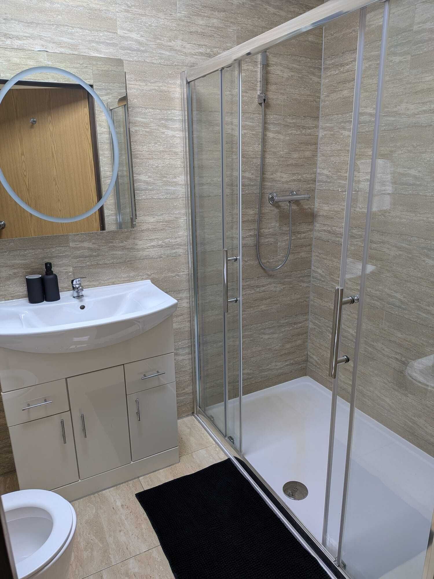 Shower, hair dryer, towels, toilet paper