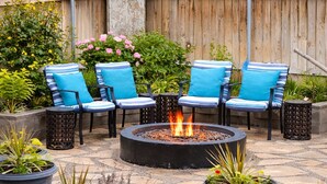 An outdoor patio with a fire pit, seating, and potted plants. - The Oasis: Private 85° Pool + Bonus Shared Spa & Resort Garden
 (Kennewick)