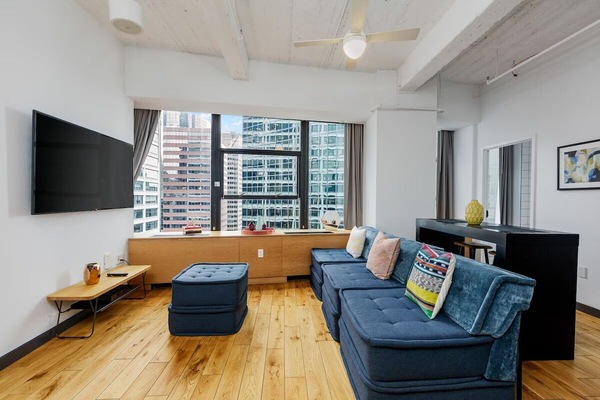 Stretch out on the deep sofa with skyline daylight.