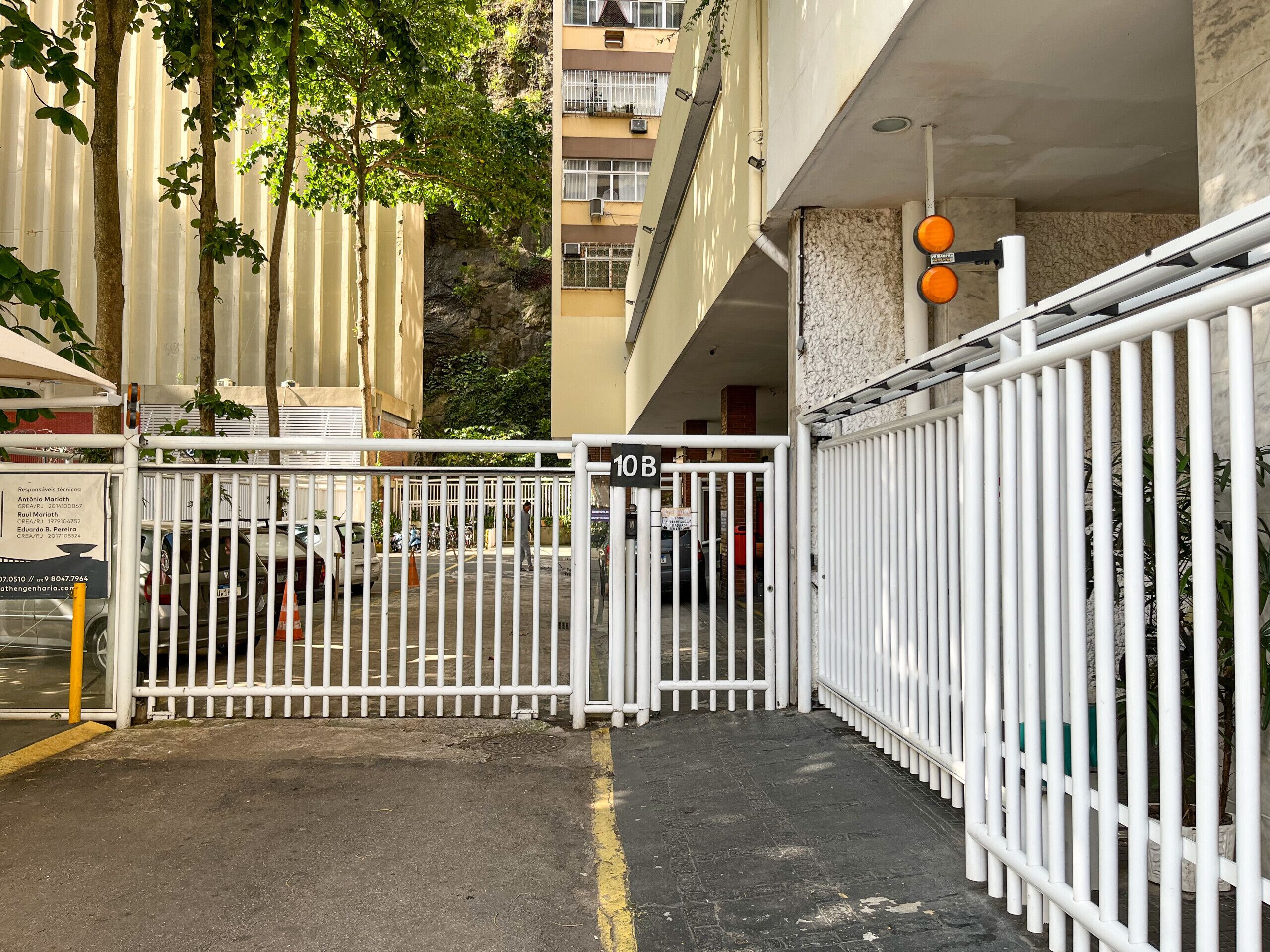 A gated entrance to a building with a sign indicating the gate number 10B.