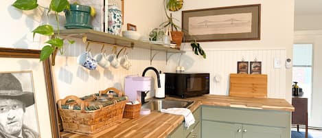 Fridge, microwave, coffee/tea maker, cookware/dishes/utensils