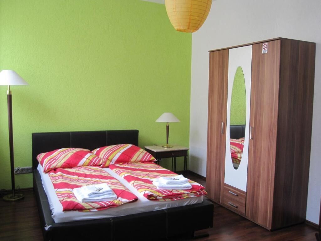 Ein Schlafzimmer mit einem Bett, einem Kleiderschrank und zwei Nachttischlampen.