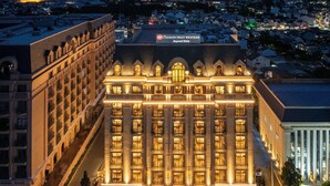 A large, multi-story hotel with a prominent entrance, illuminated signage, and a symmetrical facade. - Best Western Premier Imperial Dalat (Lam Vien - Da Lat)