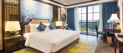 A spacious hotel room with a large bed, a balcony with a view, and a decorative wall.