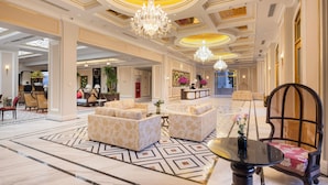 A spacious lobby with a reception desk, seating areas, chandeliers, and a patterned floor. - Best Western Premier Imperial Dalat (Lam Vien - Da Lat)