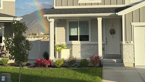 A two-story house with a front porch, a garage, and a driveway. - Magical Mountain-View Retreat SwimSpa-Hot Tub , Fire pit & Cozy Living Spaces  (Salem)